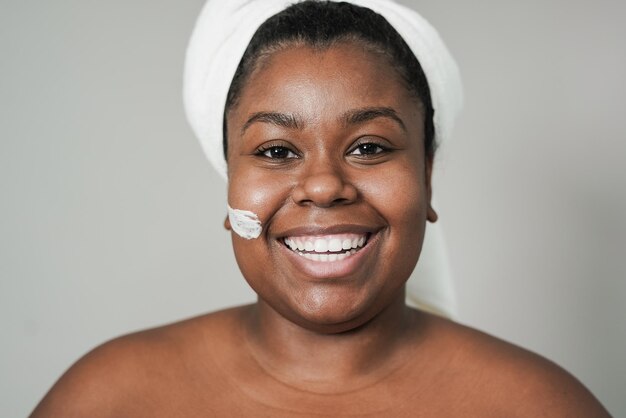 Young curvy african woman smiling on camera during spa day Beauty treatment concept