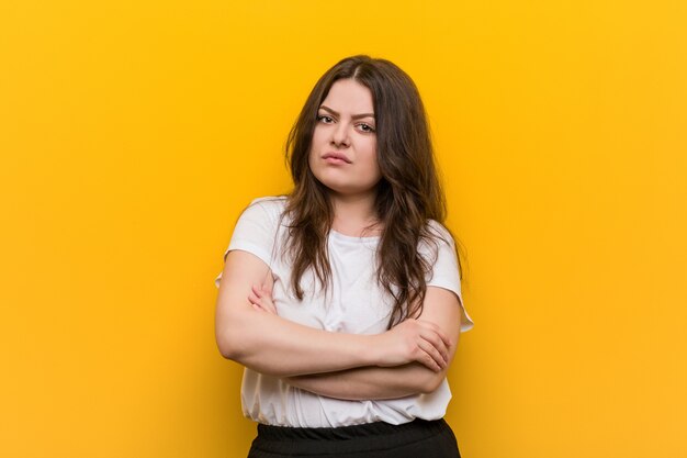 Young curvy plus size woman unhappy looking with sarcastic expression