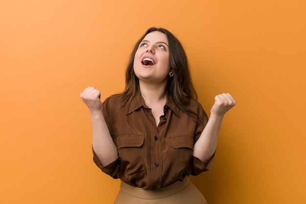 Young curvy russian woman cheering carefree and excited. Victory concept.