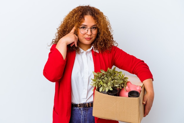 Young curvy woman moving to a new home isolated on white background pointing temple with finger, thinking, focused on a task.