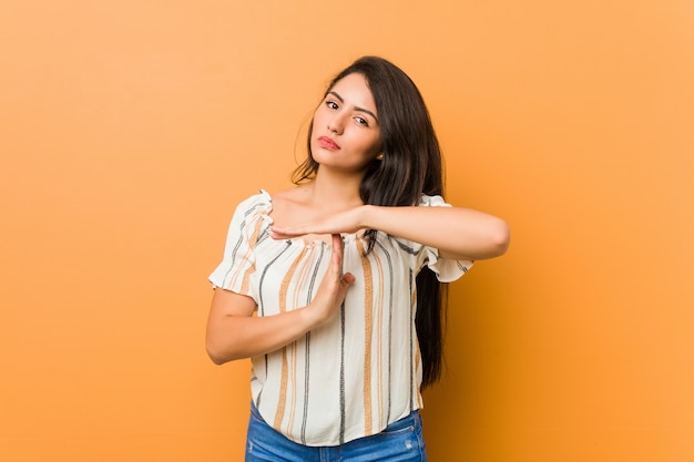 Young curvy woman showing a timeout gesture.