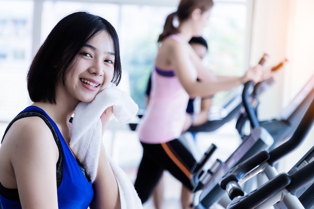 Young cute asian girl wear sport wear is relax after cadio workout in fitness health club