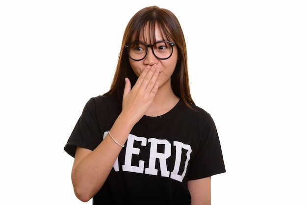 Young cute Asian nerd teenage girl looking shocked