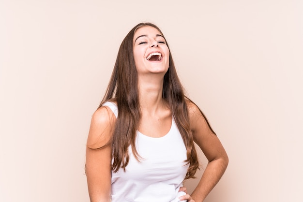 Young cute caucasian woman against a beige background