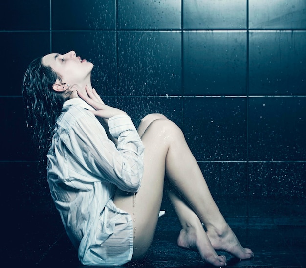 Young cute curly girl taking a shower