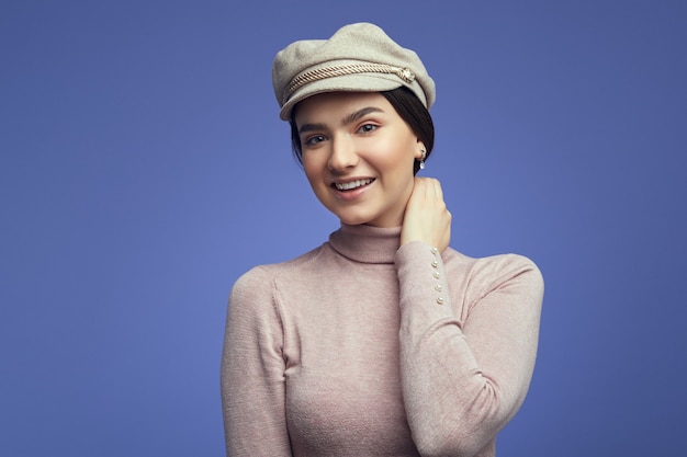 Young cute girl dressed in casual clothes smiling over purple background