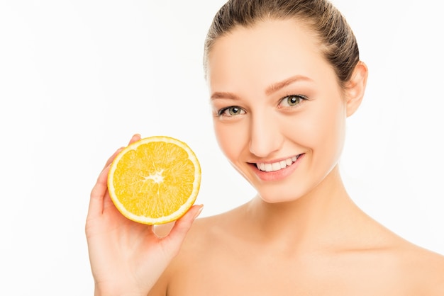 Young cute girl with nice smile and orange slice