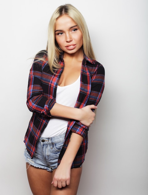 Young cute smiling blond girl, over white background