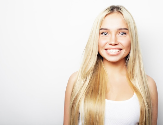 Photo young cute smiling blond girl on white background