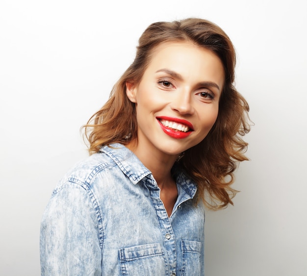 Young cute smiling blond girl over white