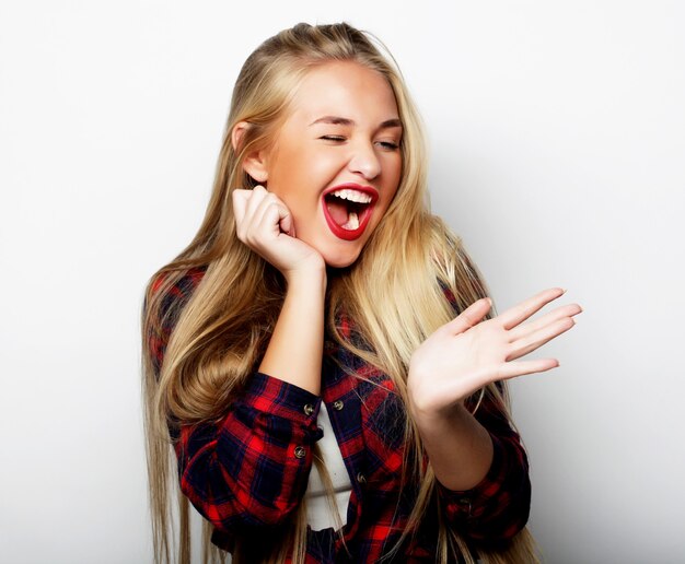 Young cute smiling blond girl over white