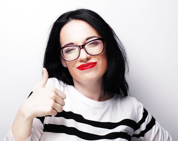 Young cute smiling brunette girl over white background