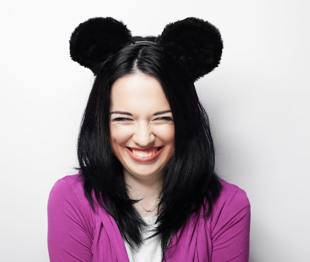 Young cute smiling brunette girl over white background