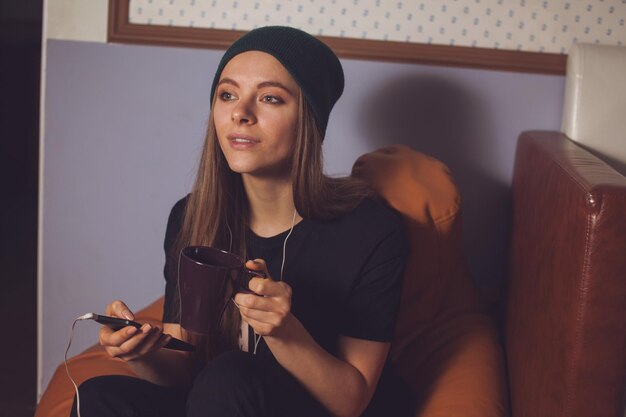 Young cute woman hipster listening music in headphones