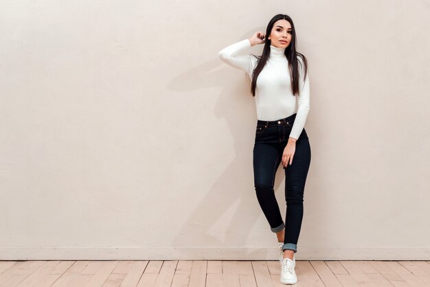 young cute woman isolated over beige wall