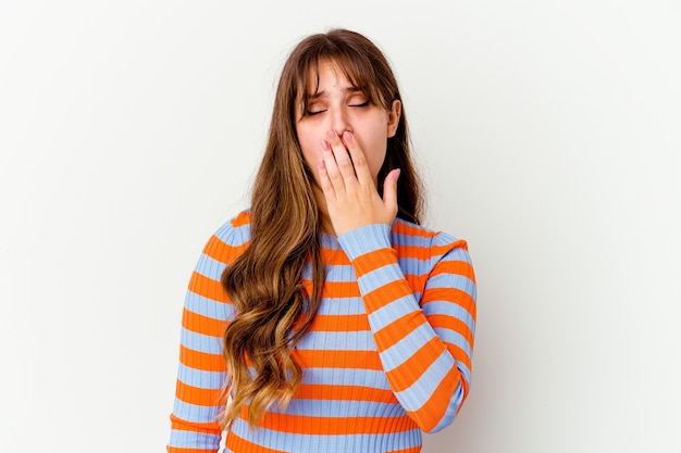 Young cute woman isolated on white wall yawning showing a tired gesture covering mouth with hand