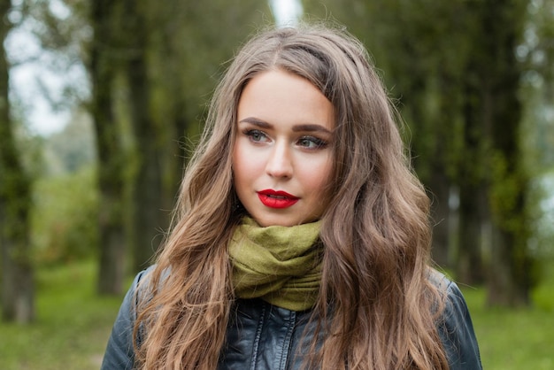 Young cute woman outdoor Perfect girl with healthy hair and makeup face closeup