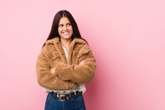 Young cute woman smiling confident with crossed arms.