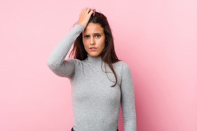 Young cute woman tired and very sleepy keeping hand on head.