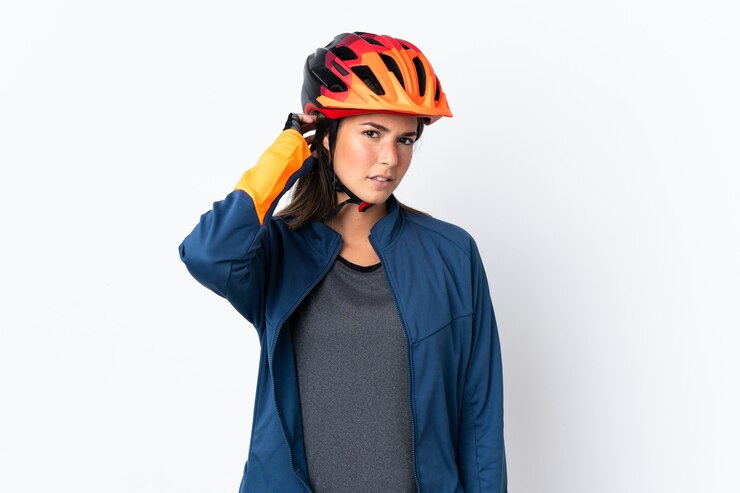 Photo young cyclist brazilian girl isolated on white  background having doubts