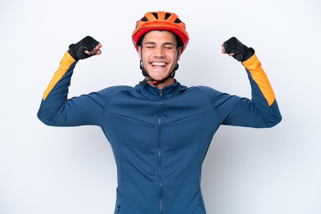 Young cyclist caucasian man isolated on white background doing strong gesture