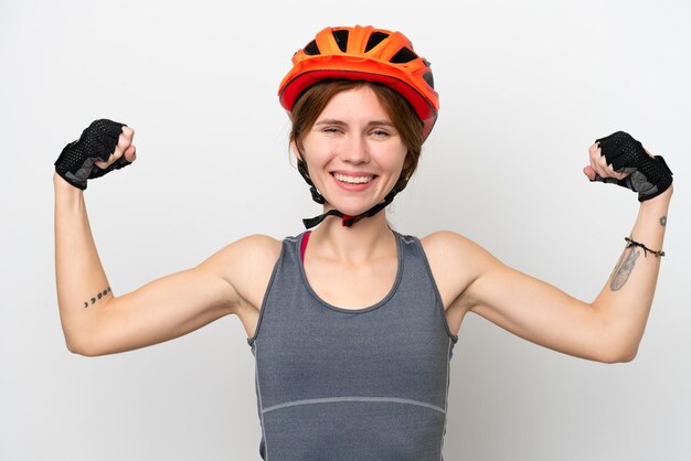 Young cyclist English woman isolated on white background doing strong gesture