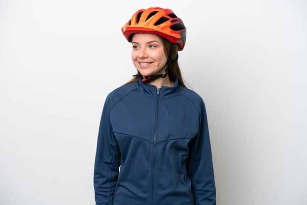 Young cyclist Lithuanian woman isolated on white background looking to the side and smiling