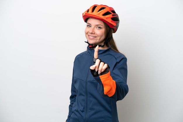 Young cyclist Lithuanian woman isolated on white background showing and lifting a finger