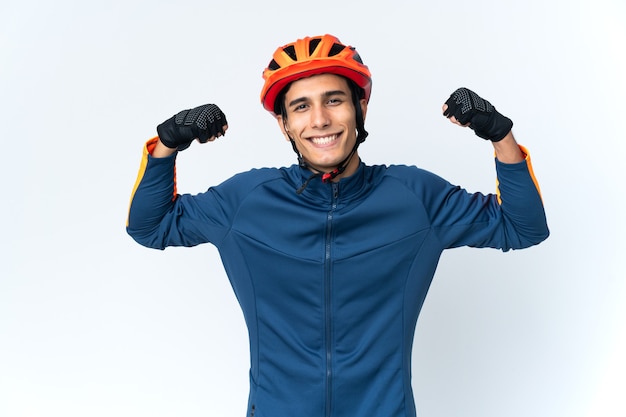 Young cyclist man isolated on background doing strong gesture