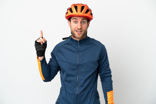 Young cyclist man isolated thinking an idea pointing the finger up