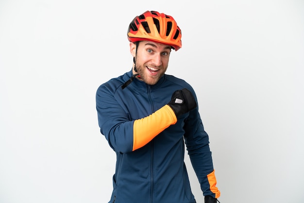 Young cyclist man isolated on white background celebrating a victory