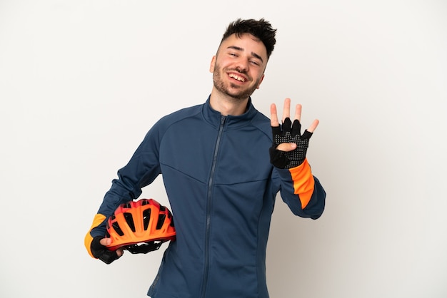 Young cyclist man isolated on white background happy and counting four with fingers
