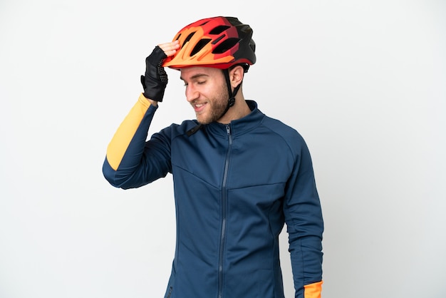 Young cyclist man isolated on white background has realized something and intending the solution