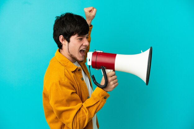 Young cyclist man isolated on white background showing thumb down with negative expression