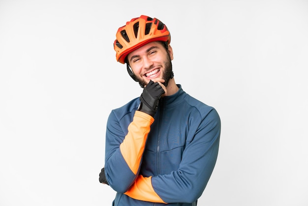 Young cyclist man over isolated white background smiling