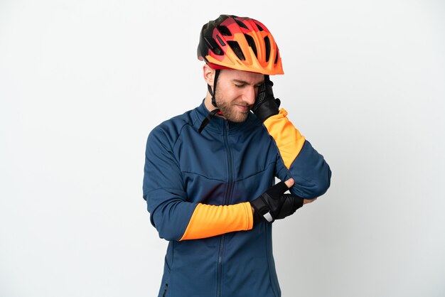 Young cyclist man isolated on white background with headache