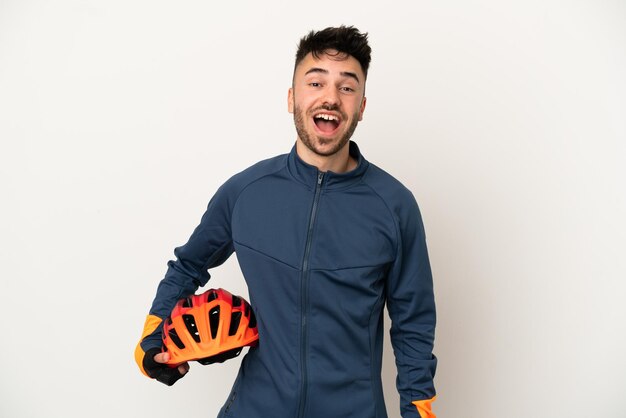 Young cyclist man isolated on white background with surprise facial expression