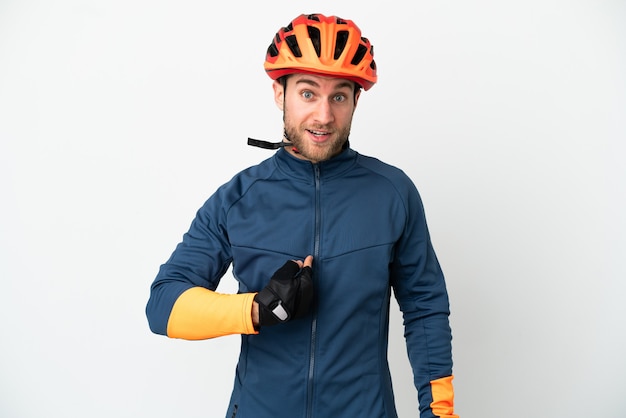 Young cyclist man isolated with surprise facial expression