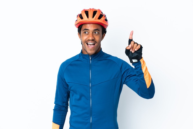 Young cyclist man with braids over isolated wall intending to realizes the solution while lifting a finger up