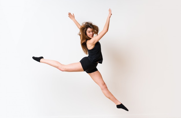 Young dance girl over isolated white wall