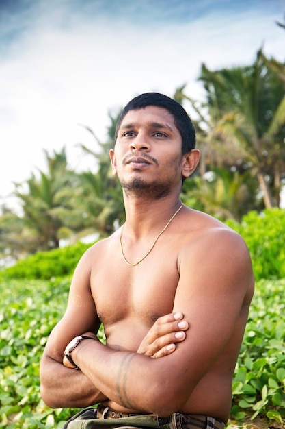 A young dark-skinned guy on the ocean