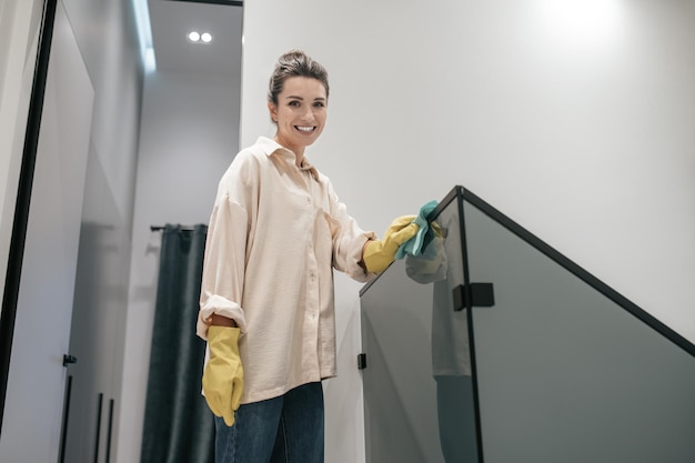 Young darkhaired woman standing at the stairs at home