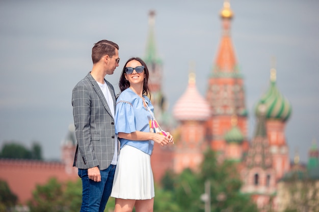 Young dating couple in love walking in city background St Basils Church