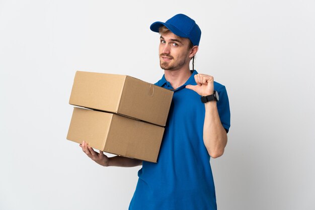 Young delivery blonde man isolated on white background proud and self-satisfied