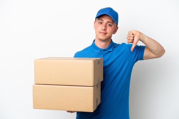 Young delivery Brazilian man isolated ops white background showing thumb down with negative expression