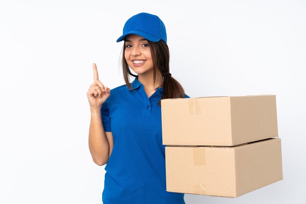 Young delivery brunette girl over isolated white background showing and lifting a finger in sign of the best