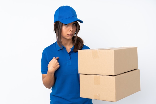 Young delivery brunette girl over isolated white wall pointing to oneself