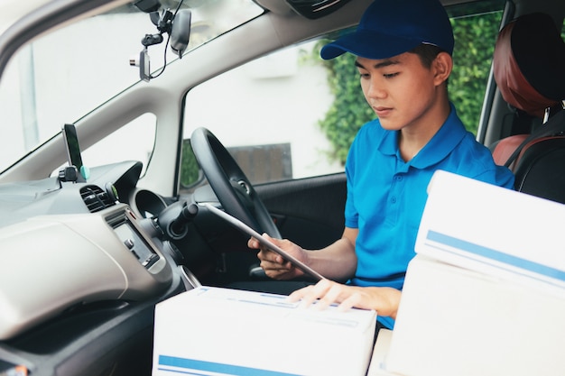 Young Delivery Man Checking Customer List