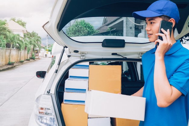 Young Delivery Man Checking Customer List