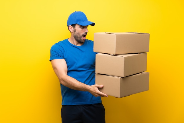 Young delivery man with boxes